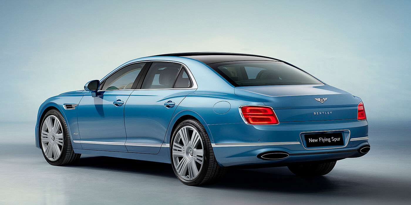 Bentley Leeds New Bentley Flying Spur Azure sedan rear view in Light windsor blue by Mulliner paint with 22 inch Azure wheels and chrome exterior details