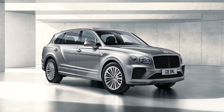 Bentley Leeds Bentley Bentayga Extended Wheelbase SUV front three quarter in Moonbeam paint with a grey background