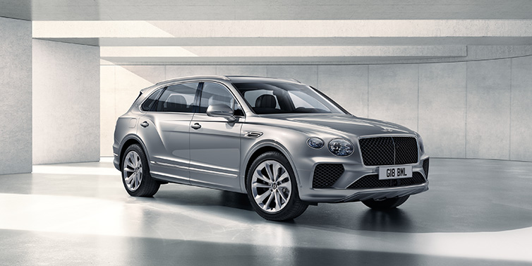 Bentley Leeds Bentley Bentayga Extended Wheelbase SUV front three quarter in Moonbeam paint with a grey background