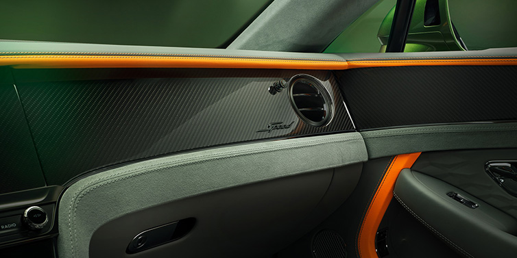 Bentley Leeds Bentley Continental GT Speed coupe front interior dash detail with high gloss carbon fibre veneer surrounded by Mandarin by Mulliner and Gravity Grey hides