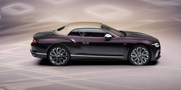 Bentley Leeds Bentley Continental GTC Mulliner convertible in profile with hood up, in Tanzanite Purple paint and 22 inch Mulliner painted and polished wheels