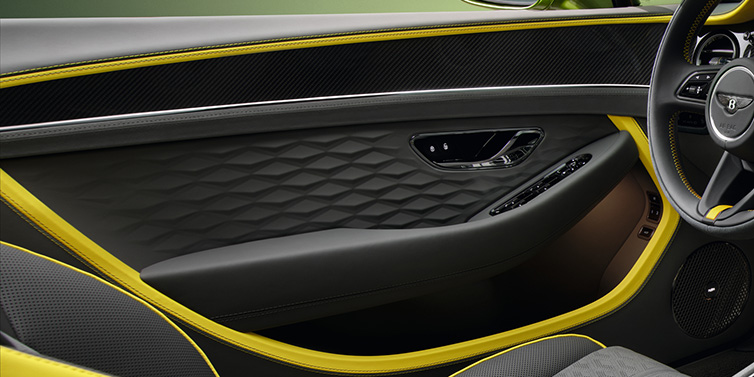 Bentley Leeds Bentley Continental GTC Speed convertible interior door details featuring Gravity Grey and Cyber Yellow by Mulliner hides and high gloss carbon fibre veneer