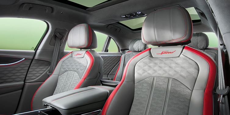 Bentley Leeds Bentley Flying Spur Speed sedan interior showing front and rear seats in Hotspur red and Gravity Grey hides, with Speed seat emblems