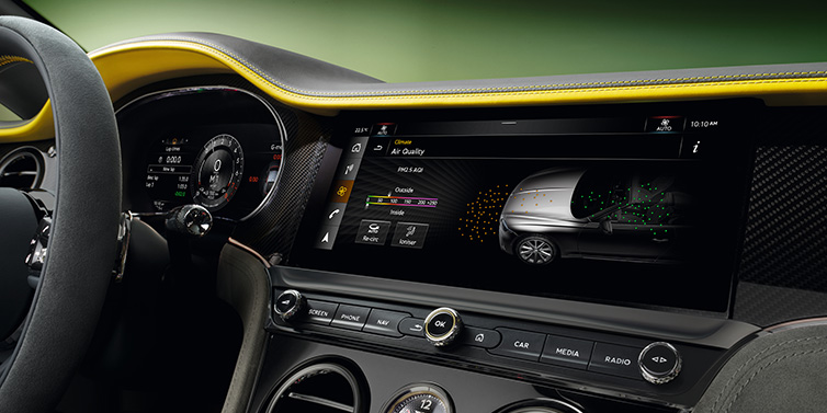 Bentley Leeds Bentley Continental GTC Speed convertible front interior centre console with MMI screen showing Air Quality visualisation surrounded by Cyber Yellow by Mulliner and Gravity Grey hides and high gloss carbon fibre veneer