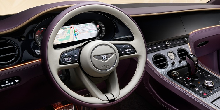 Bentley Leeds Bentley Continental GT Mulliner coupe front interior showing steering wheel and drivers screens surrounded by Linen and Damson hides and Grand Black veneer