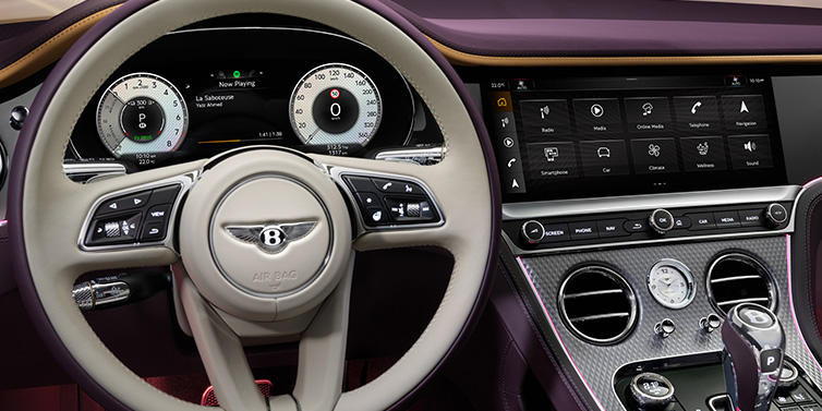 Bentley Leeds Bentley Continental GTC Mulliner convertible steering wheel and drivers screens surrounded by Damson purple and Linen hides